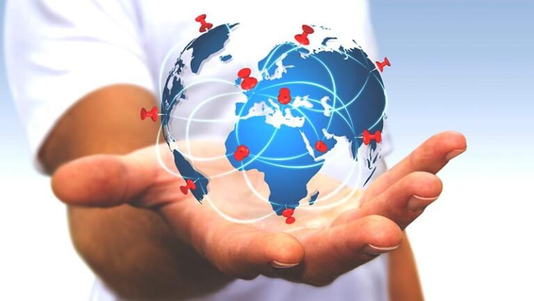 Businessman with digital world map and pins floating over his hand