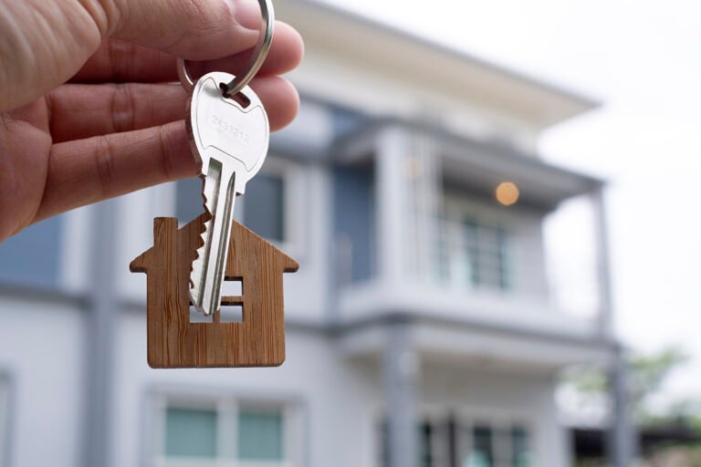 Landlord unlocks the house key for new home.  Real Estate Agents